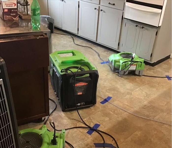 Kitchen in home with SERVPRO equipment on the floor