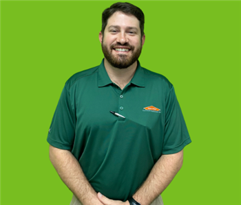 Male SERVPRO employee on green background