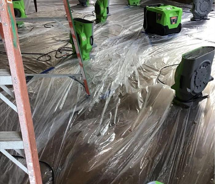 Drying area with dehumidifiers and fans running