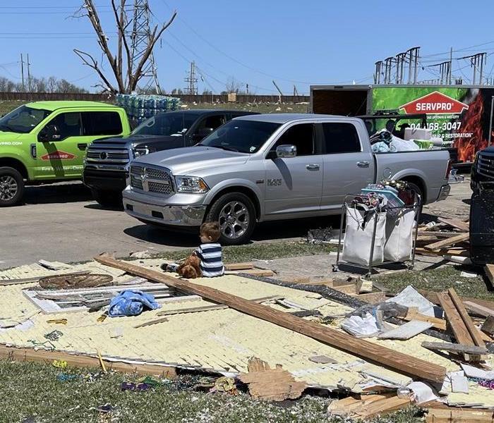 Devestation after tornado with child sitting on damage