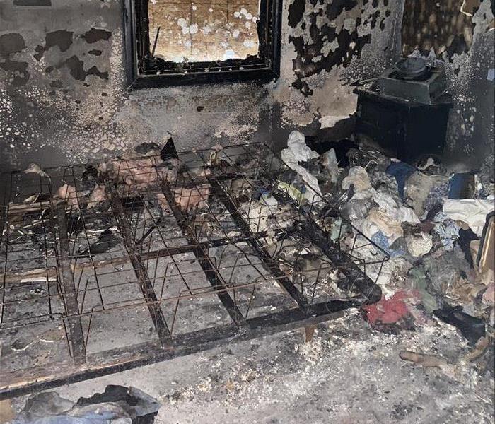 Bedroom scorched after fire with nothing left but debris