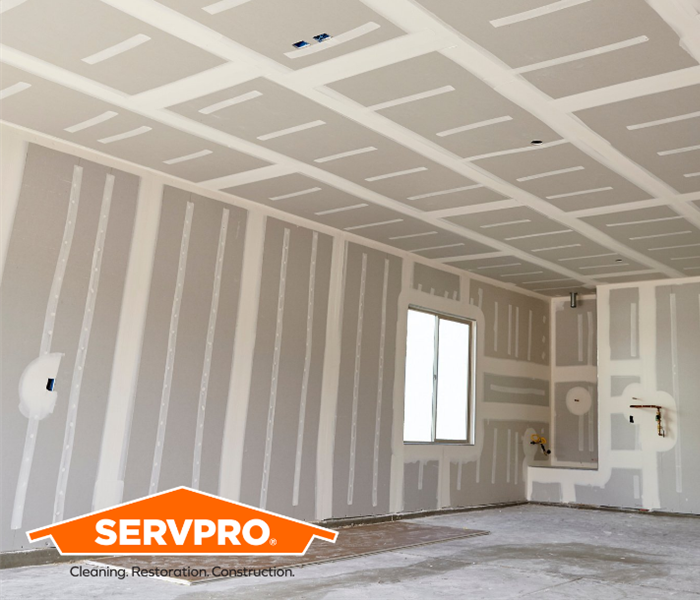 Freshly replaced drywall with SERVPRO logo 